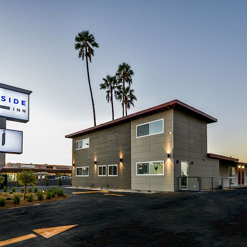 The image shows a modern building with a sign that reads 