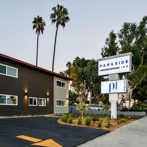 This image shows a modern, two-story building with a sign that reads 